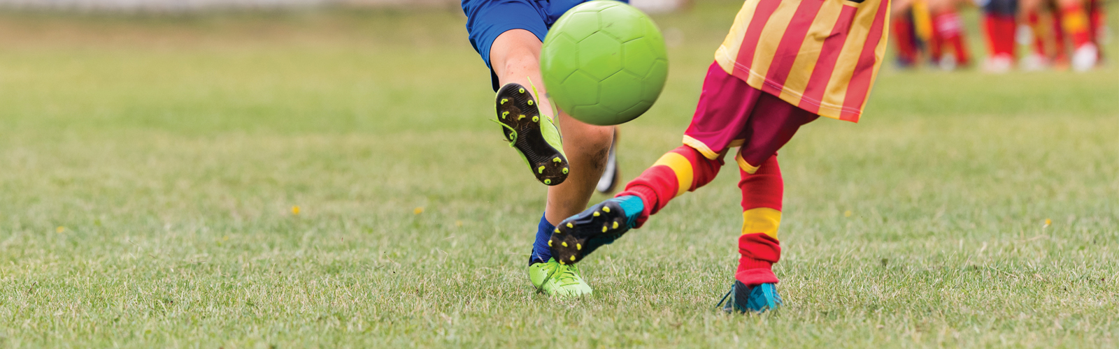 kids kicking a soccer ball