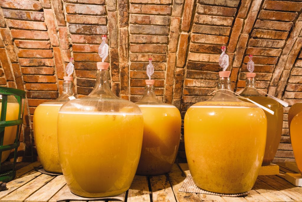 juice is fermented by yeast in jars