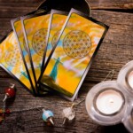 playing cards and candles on a wooden table