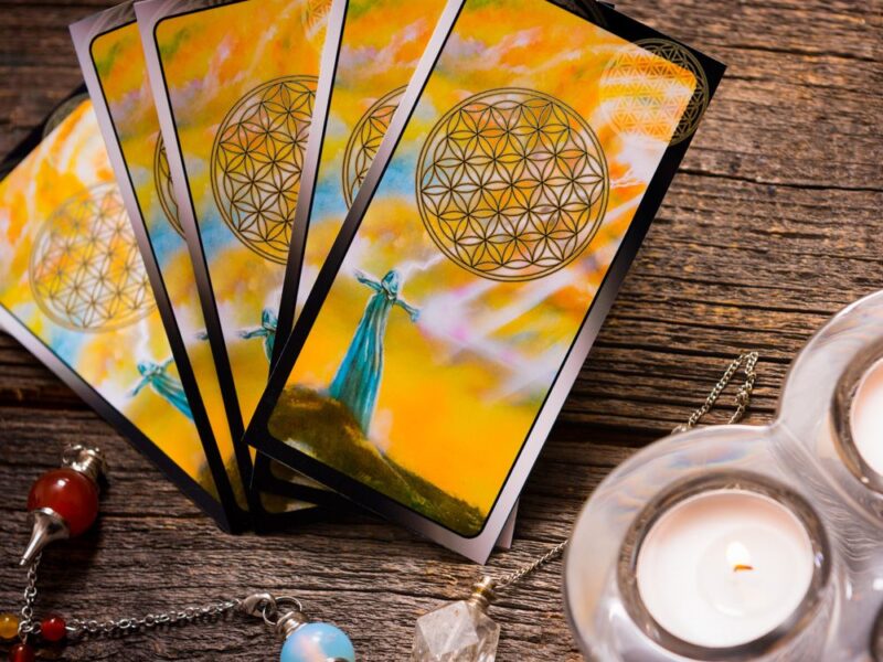 playing cards and candles on a wooden table