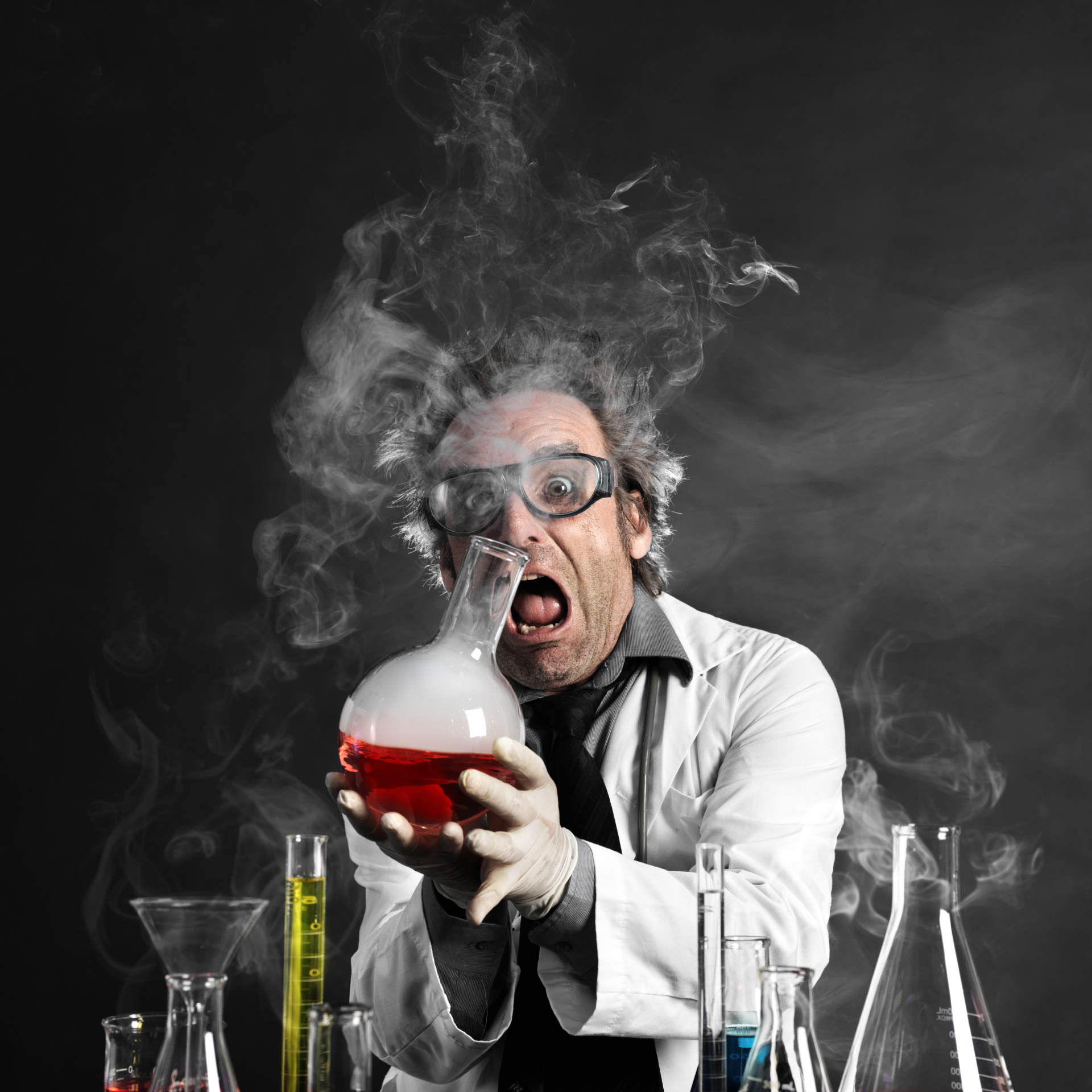 Mad scientist holding a smoking flask
