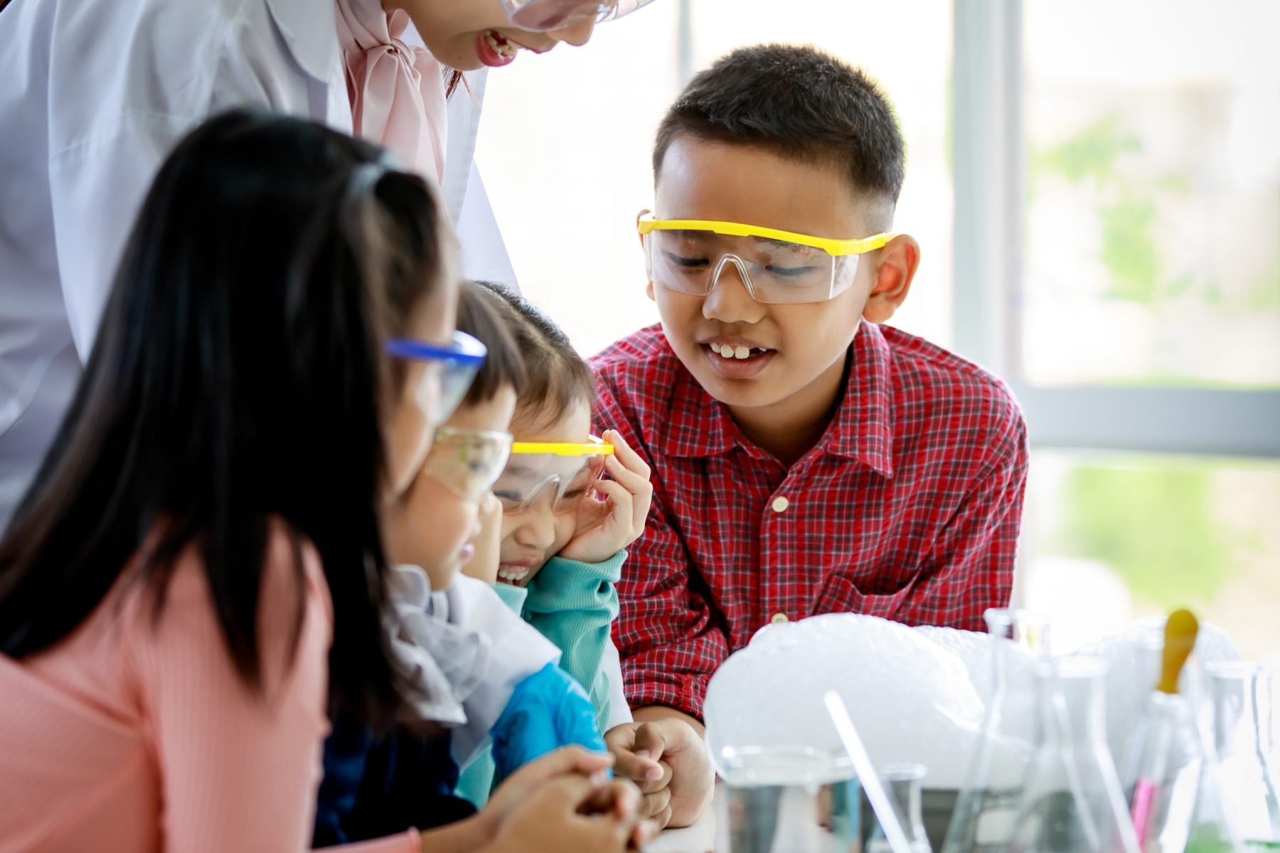 Asian,Female,Elementary,School,Science,Teacher,In,Lab,Coat,Holding