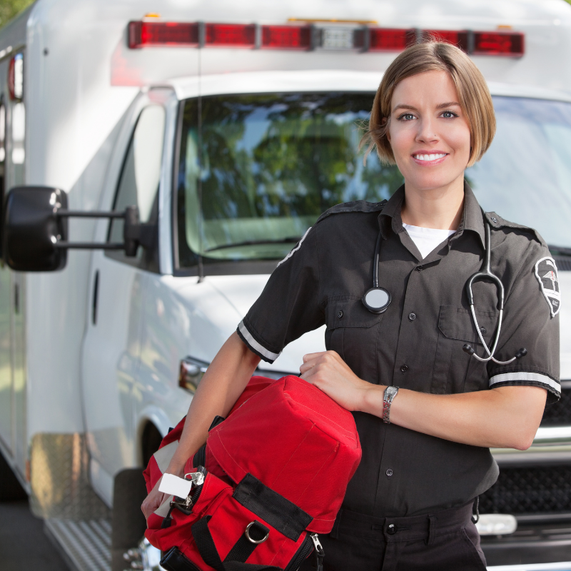 Paramedic carries a portable oxygen unit.
