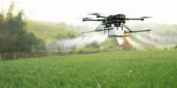 drone flying over a green field