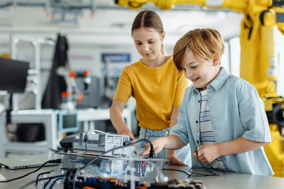 students working on science project together in classroom