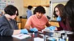 Students and teacher in high school science class