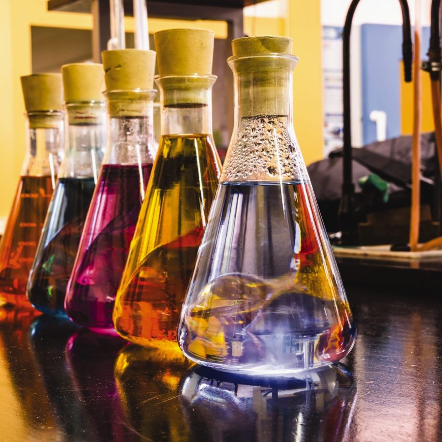 Flasks of colorful liquid sit on the lab bench